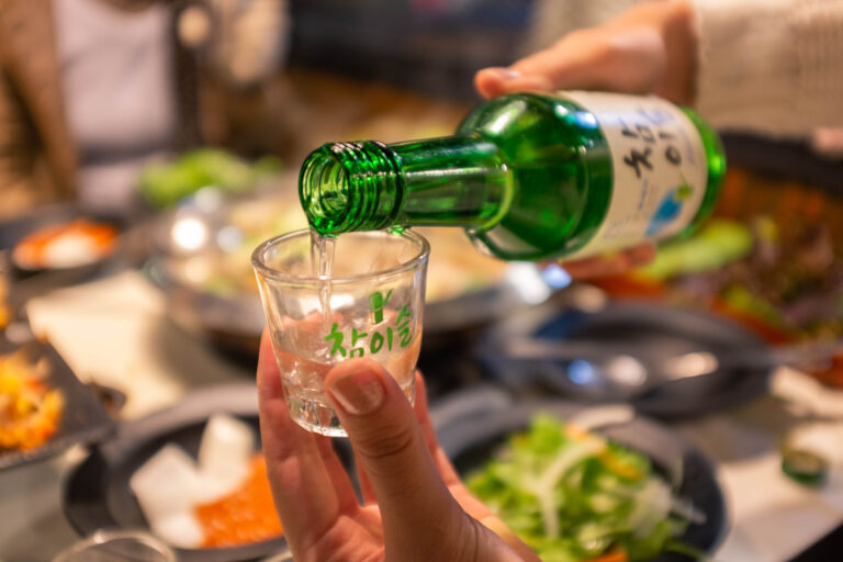 Restaurant,In,Seoul,south,Korea-january,2016;,Pouring,Soju,In,Glass,With